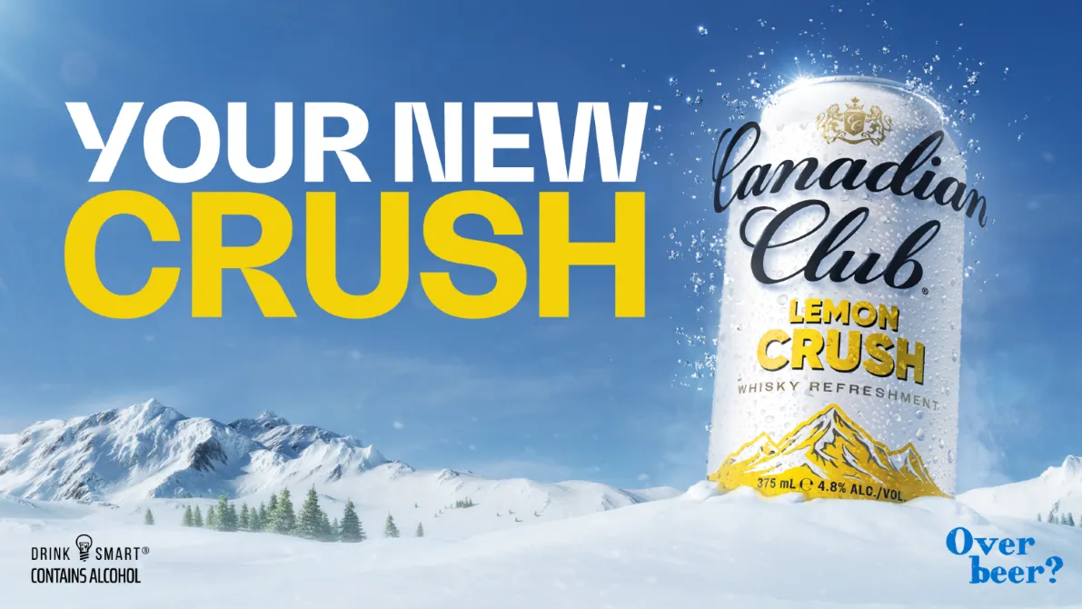 A can of Canadian Club Lemon Crush on snow-covered mountains, advertising a refreshing whisky beverage with the tagline "Your New Crush".